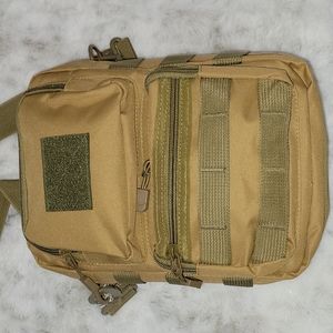 Tan canvas crossbody or shoulder bag. Lots of pockets